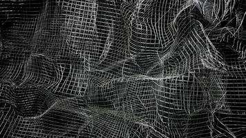 Crumpled mesh. Abstract background. Metal mesh with shadow on a black background. The surface of a large roll is damaged by wire mesh. photo