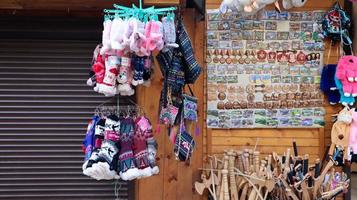 Souvenir market in Yaremche with traditional Carpathian handmade clothing, herbs and wooden tools. Ukrainian textiles, knitted socks, vests, hats. Ukraine, Yaremche - November 20, 2019 photo