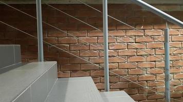 Red brick building with a modern staircase in a loft style with metal railing. Stairs adorn the building. Modern stairwell. Steel railing. Staircase in perspective. photo