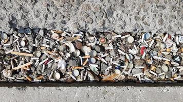 A lot of cigarette butts. The cause of lung cancer. Many used cigarette butts as trash photo