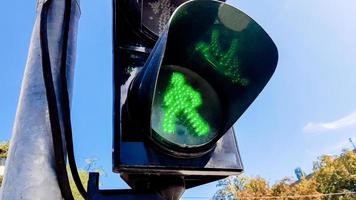 Traffic light with green light and safe for movement. Pedestrian traffic light. Green man photo