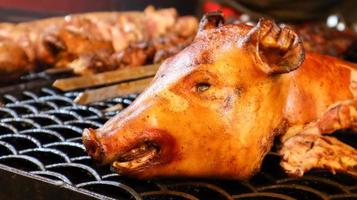 The head of a whole fried pig. Grilled pork. fried pork head. Babi Guling is a crispy fried pig, a favorite Indonesian street food in Bali. Zoological image of a pig showing its head. country animal