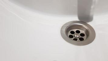 white ceramic washbasin with chrome faucet in the toilet with gray tile photo