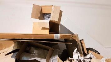 Brown cardboard boxes are stacked for recycling. photo of waste paper, a stack of cardboard for processing. Zero waste concept, waste recycling, garbage sorting. Earth Day