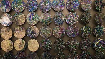 Macro close up of sparkles. Abstract background with gray sparkles. Texture scales of round spangles with color transition. Sequin background. Template for design. Festive background. photo