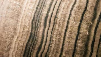 The surface of Sandstone with wavy brown veins. Sulphide agate texture. Wide image of brown natural stone texture Sphalerite. Beautiful wavy pattern of cut of Schalenblende stone close-up photo