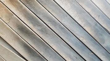 Gray wooden background with diagonal lines. Board background with copy space. Wooden old boards with cracked gray paint on the diagonal. Selective focus. Textured wooden background. photo