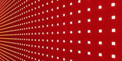 RGB LED screen panel texture. Close-up of a pixel LED screen with bokeh for wallpaper. Bright red abstract background perfect for any design. photo