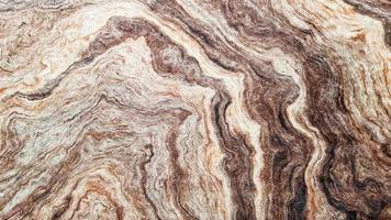 The surface of Sandstone with wavy brown veins. Sulphide agate texture. Wide image of brown natural stone texture Sphalerite. Beautiful wavy pattern of cut of Schalenblende stone close-up photo