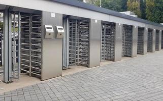 Entrance to the football stadium during the day without people. Secure entrance gates - outdoor turnstiles at the stadium. Guarded entrance. photo