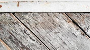 Gray wooden background with diagonal lines. Board background with copy space. Wooden old boards with cracked gray paint on the diagonal. Selective focus. Textured wooden background. photo