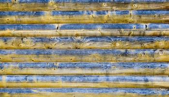 Old wood background or texture. Old pine horizontal boards. The wood texture is black and yellow with rings from knots and cracks. Abstract wooden background. photo