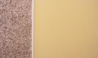 decorative plaster and semi-painted wall in beige. Textured background. Two color wall. The yellow and beige background is painted in two different colors. Abstract wallpaper. copy space photo