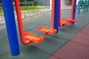 Exercise machines and fitness equipment for exercising on an open air sports ground in cloudy rainy weather without people. photo