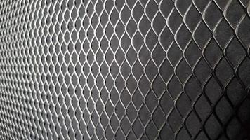 Metal mesh seamless pattern. Black metal mesh texture on a black background. Bulletin board for text and message design. Rhombus shape photo