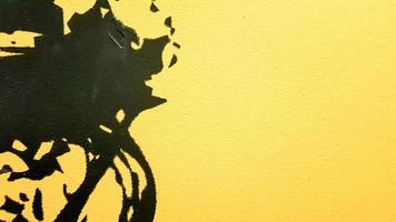 Black abstract paint splashes dripping on a bright yellow background. Black paint splashes on a yellow background. concept of art ideas. Paint brush texture yellow and black on background photo