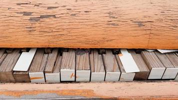 Closeup of a broken piano keyboard of an old piano. photo