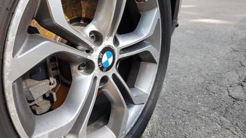 Ukraine, Kiev - August 28,2019. Original BMW alloy wheel dirty and scratched with tires on a car close-up photo