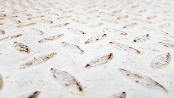 White steel sheet with embossed diamond pattern, used for floors and industrial building. White vintage steel plate useful as background photo