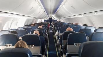 Passengers are waiting for the departure of an Aeroflot flight on a Boeing aircraft before the intercontinental flight. Tourists traveling by plane shot from inside the plane photo