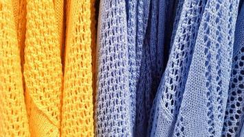 Colors of rainbow. Variety of casual shirts, t-shirts on hangers in a store. Cloth cotton of various bright colors close-up. Textile background photo