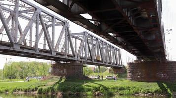 Railway bridge over the river, bottom view in the summer. photo