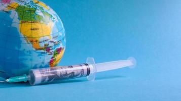 Ukraine, Kiev - April 15, 2020. Globe from the side of America full of syringes. To illustrate the need for a vaccine to fight the global pandemic in the United States caused by the Covid-19 virus. photo