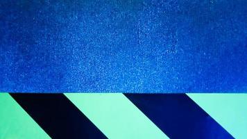diagonal yellow and black stripes on a blue problem wall. Abstract colorful minimalist pattern. Warning warning sticky tape on blue background photo