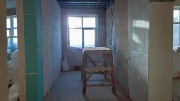 Repair in the apartment. Grunge wooden staircase. The concept of registration of the apartment. bench for painting the ceiling. photo