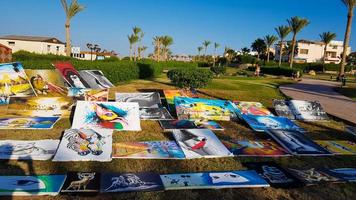 Egypt, Sharm El Sheikh - June 20, 2019. paintings for sale on the street in a park in the Amway Hotel. Flea market and street gallery of art and creativity. photo