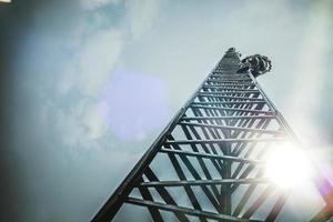 Telecom Worker Climbing Antenna Tower photo