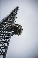 Telecom Worker Climbing Antenna Tower photo