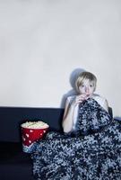 Girl listen to horror or suspense movie alone. photo
