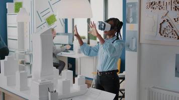 Architect using vr glasses to design building model and construction layout
