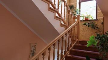 Luxurious wooden staircase to the bedroom to the second floor in a country house or villa. photo