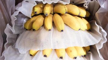 Ripe bananas in a box in a store. At the display window. photo