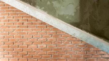 Red brick building with a modern staircase in a loft style with metal railing. Stairs adorn the building. Modern stairwell. Steel railing. Staircase in perspective. photo