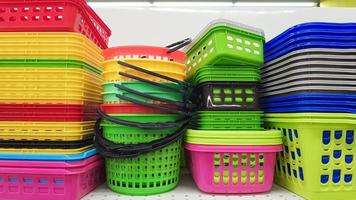 Multi-colored plastic containers of different shapes and sizes with and  without lids, stacked in a pile on a store window. Sale of boxes for  storage and cleaning. Modern kitchen utensils 4548225 Stock