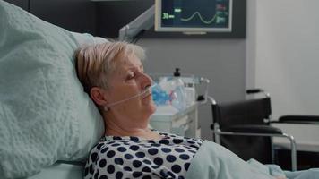 Portrait of retired woman with sickness laying in bed video