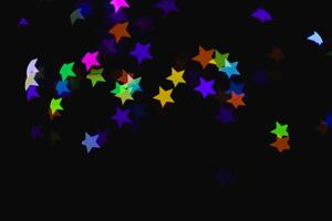 light colorful blue star light effect isolated overlay glitter texture on black. photo