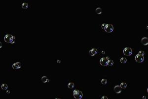 transparent bubbles soap pattern overlay abstract particles splashes of water on black. photo