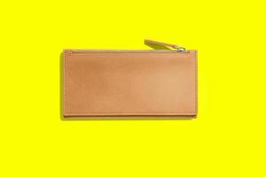 Fashionable leather women's wallet on a yellow background. added copy space for text. photo