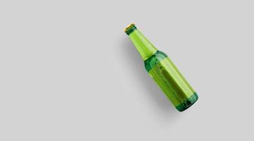 Top up view green beer bottle with blank yellow template isolated on grey background. beer fiesta concept. photo