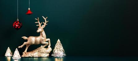 Christmas gold reindeer with xmas tree lamp lights with red baubles hanging on blue green photo