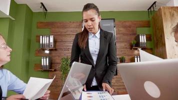 Businesswoman talking with her team in a meeting video