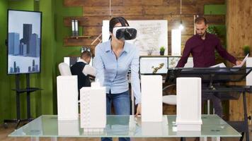 Female architects exploring virtual reality project of business buildings video