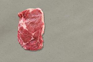 Close up view red fresh rib eye on kitchen table. isolated on white background. photo