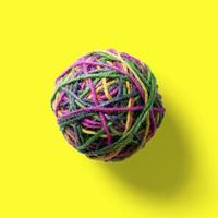 Top up view colorful jute ball isolated on yellow. photo