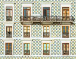 Facade of a building covered with traditional Portuguese tiles. Typical building decoration in Lisbon, Portugal photo