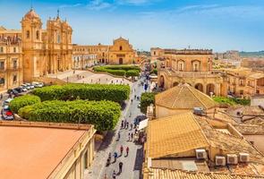 Cityscape of Noto. View of the central street with walking tourists. Province of Syracuse, Sicily, Italy